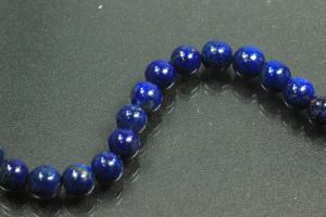 Lapis Lazuli spherical gemstone strand blue, approx. dimensions Ø 6mm, approx. 39,5cm long. Quality feature “A”. This gemstone strand was provisionally strung on blue pearl silk for further processing.